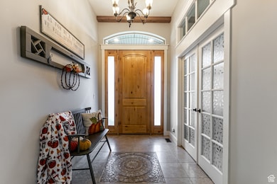 Entryway featuring healthy amount of natural light, a chandelier, and french doors