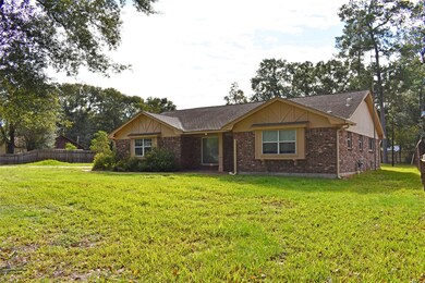 The expansive front yard is a blank canvas for any gardening enthusiast.