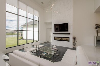 19 ft. ceilings and wall of windows with view of the lake. 15 ft. commercial window. 6 ft. electric fireplace with tiled wall surround that reaches to the ceiling.