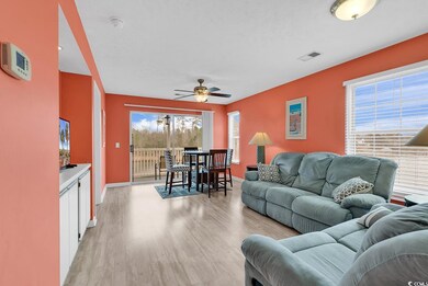Living area featuring plenty of natural light, visible vents, light wood finished floors, and ceiling fan