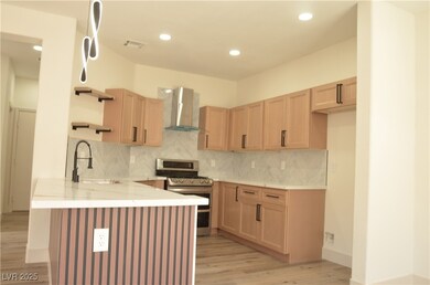 Kitchen with gas range, wall chimney exhaust hood,