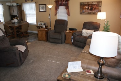 Living room featuring carpet flooring and baseboards