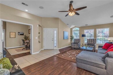 Living area with baseboards, visible vents, a ceil