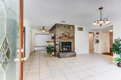 Floor To Ceiling Fireplace and Tiled Living Room