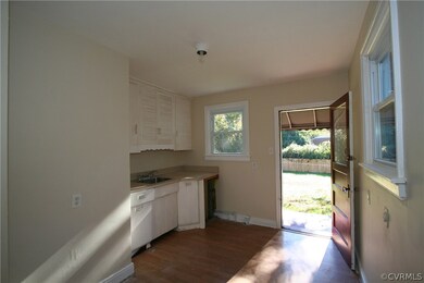 Kitchen opens to stoop and to back yard.