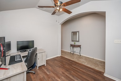 A large archway leads to the entry area in this ve