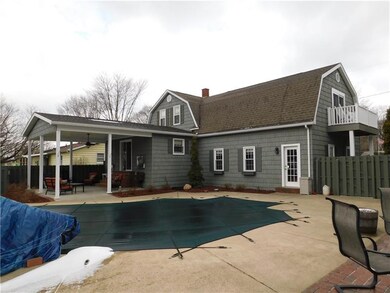 REAR OF HOME. COVERED REAR PATIO EXITING FROM KITC