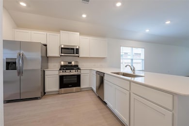 Kitchen featuring appliances with stainless steel