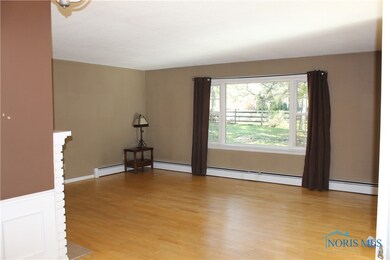 Large picture window in living room overlooks rear