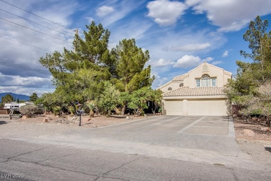 View of front of home with a garage and driveway