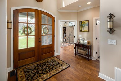 Grand foyer with custom made 8' doors. Office to the left when you walk in.   