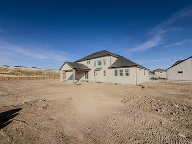 Rear view of property featuring a patio and a shingled roof
