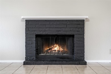 Detailed view of a brick fireplace and baseboards