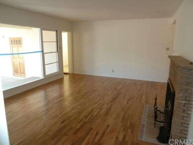Living Room with large bright windows & fireplace
