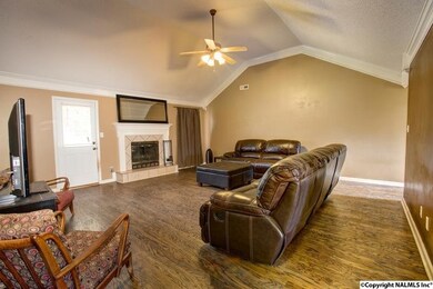 The family room features 9' ceilings, vaulted ceilings, crown moulding, a fireplace, and wood floors.