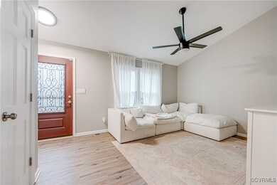 Living room with light wood-type flooring, a ceili