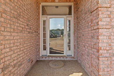 Entrance to property with brick siding