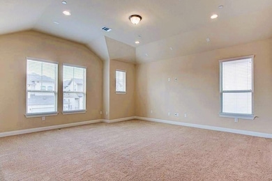 Spare room featuring vaulted ceiling, light carpe