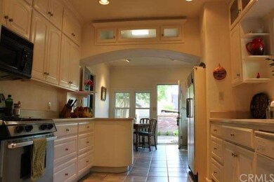 Kitchen view to small breakfast eating room and ba