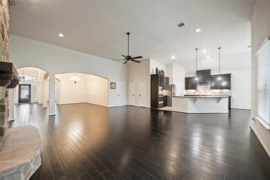 The formal dining or den is open to the living room, and kitchen