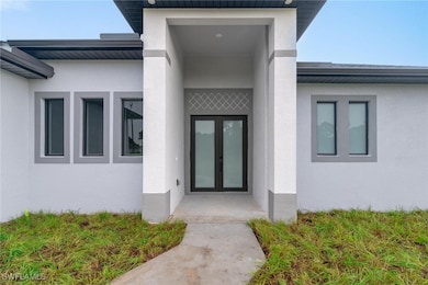 Doorway to property with stucco siding and french