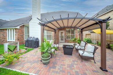 Serene extended patio with custom fountain and covered pergola is an ideal way to start/end each day.