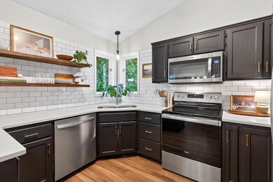 Newly enameled cabinets w gold hardware.