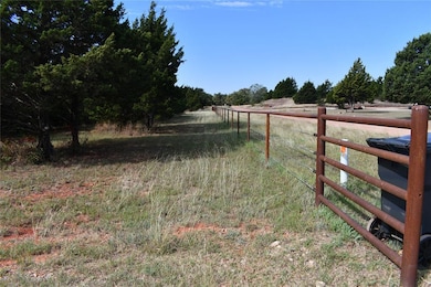 View of yard featuring a view of countryside and view of scattered trees