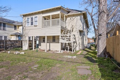 Rear view of house featuring stairs and fence