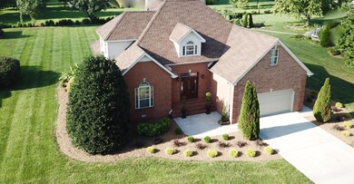 An aerial view of the front of your home shows a manicured lawn and landscaping.