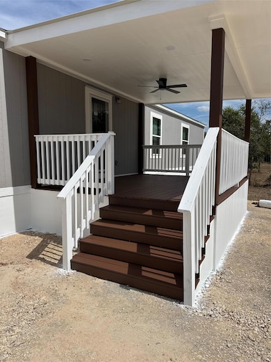 Property entrance featuring ceiling fan and a deck