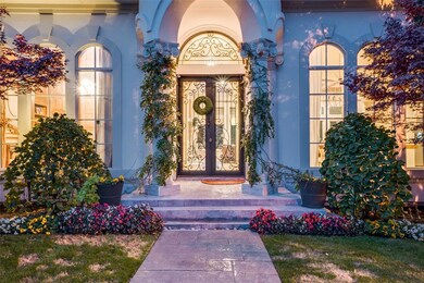 Grand entrance with custom wrought iron door and t