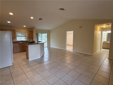Kitchen with freestanding refrigerator, a sink, da