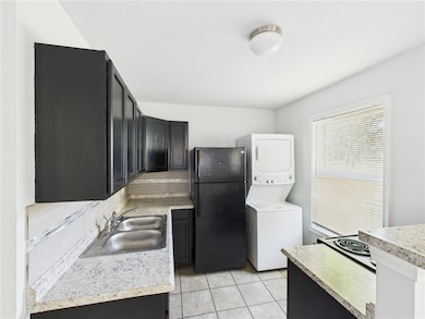 Kitchen featuring freestanding refrigerator, stack