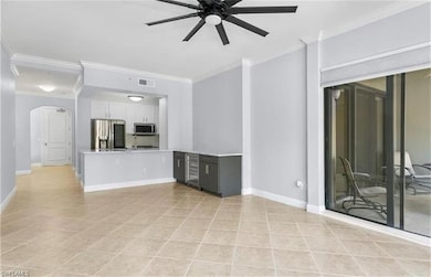 Unfurnished living room with crown molding, light 
