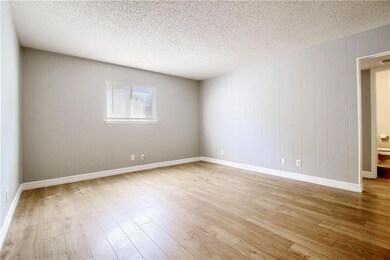 Spare room with light wood finished floors and a textured ceiling