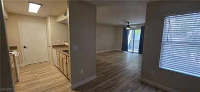 Kitchen featuring white appliances, light wood-style floors, ceiling fan, and light countertops