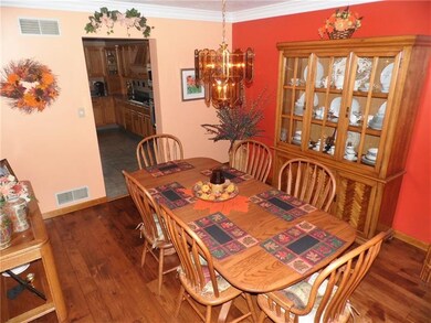 Dining room has custom floors and crown molding.