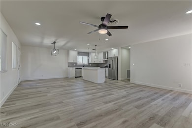 Unfurnished living room with recessed lighting, light wood-style flooring, and ceiling fan