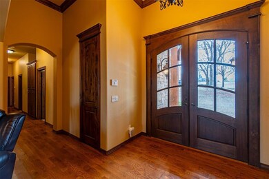 Foyer entrance with dark hardwood / wood-style flo