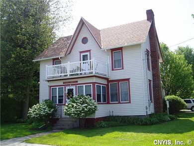 Exterior Front. The enclosed porch and the upper d
