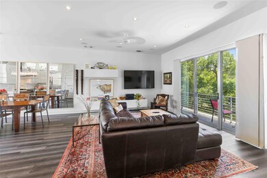 Living room featuring dark wood-style flooring, a