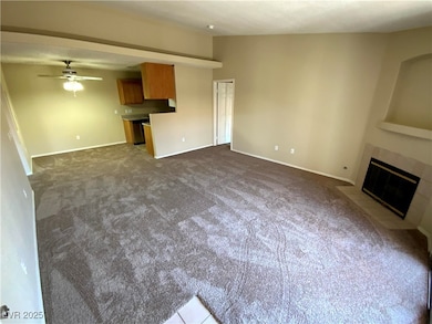 Unfurnished living room with ceiling fan, baseboar
