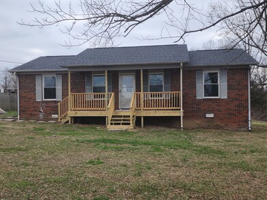 Brick ranch with new dimensional shingle roof cover front deck close to i40