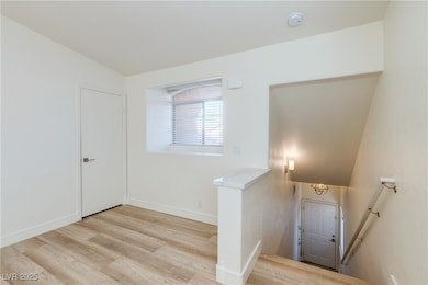 Stairs with baseboards and wood finished floors