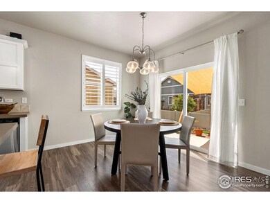 Dining room featuring LVP floors and sliding glass door which opens to the fenced in backyard with patio