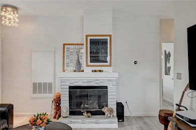 Living area featuring a tiled fireplace, wood fini