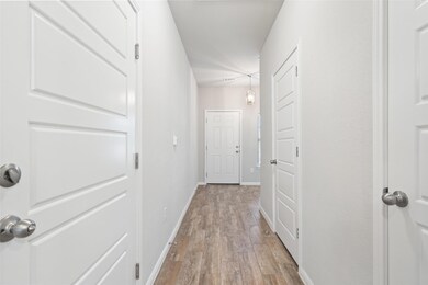 Hall featuring light wood-style flooring and baseboards