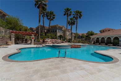 View of pool featuring a patio, a pergola, and a pool with connected hot tub