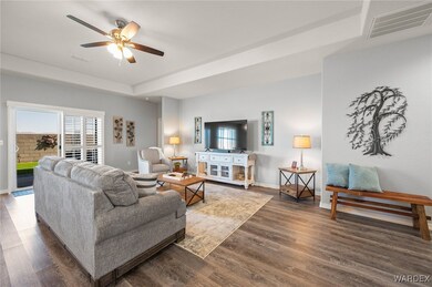 Living room with ceiling fan, dark hardwood / wood